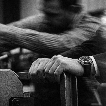 A consultant inspecting machinery on a shop floor